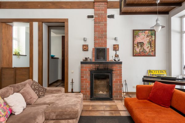 Brick fireplace near couches in living room