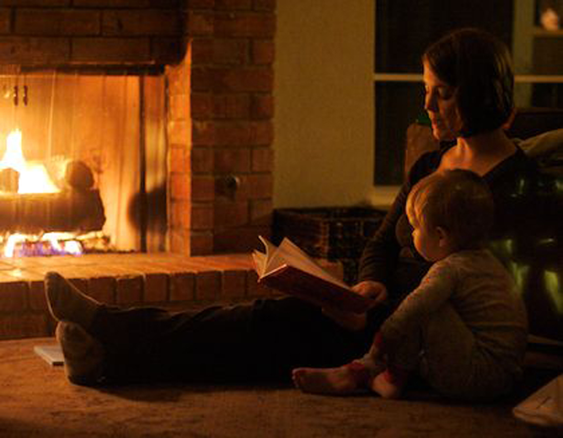 mom and child by fireplace