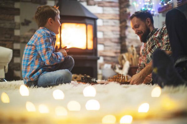 Father and son enjoying Christmas holidays at home